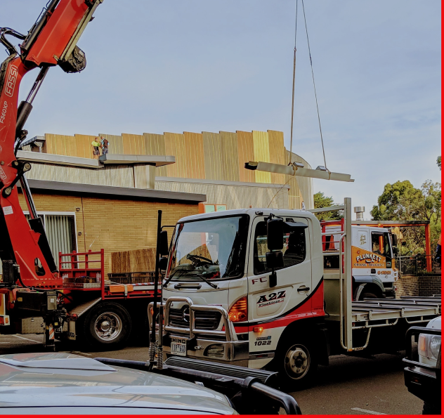 A2Z Staff truck with crane lifting colorbond steel